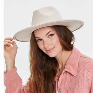A woven cowboy hat featuring a wide brim, pinched crown, and velvet trim.